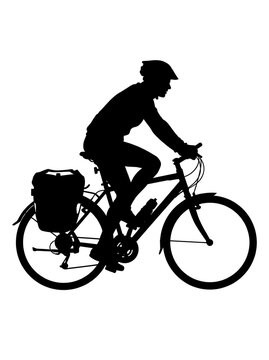 Cyclist on a touring bike with a pannier bag in silhouette