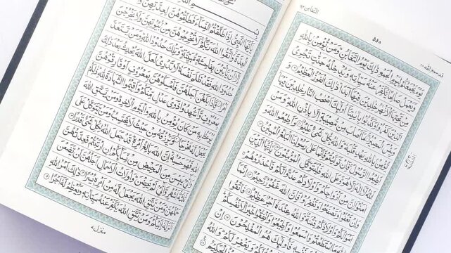 Holy quran pages turning on white background with arabic calligraphy text and intricate borders