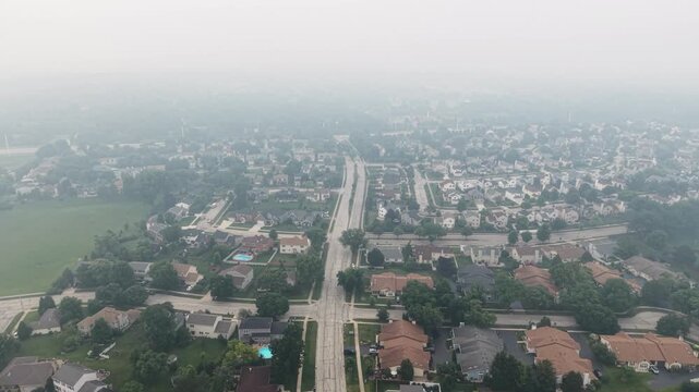 Drone footage of thick Canadian wildfire smoke blanketing Naperville, Illinois, creating hazardous air quality conditions on July 16, 2026