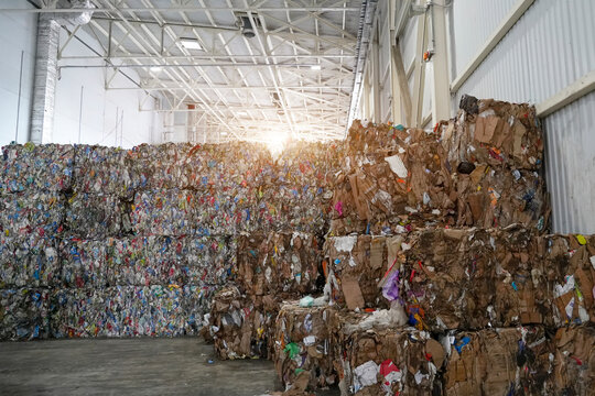 Final stages of being sent to the next stage. Pressed packs and cardboard, folded into cubes at a waste sorting and recycling plant.