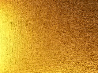 Naklejka premium ​Shiny gold textured background with rough metallic surface