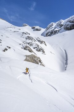 Lone ski tourer in mountain landscape with snow, ascent to Wildstrubelh&uuml;tte, Bernese Alps, Switzerland