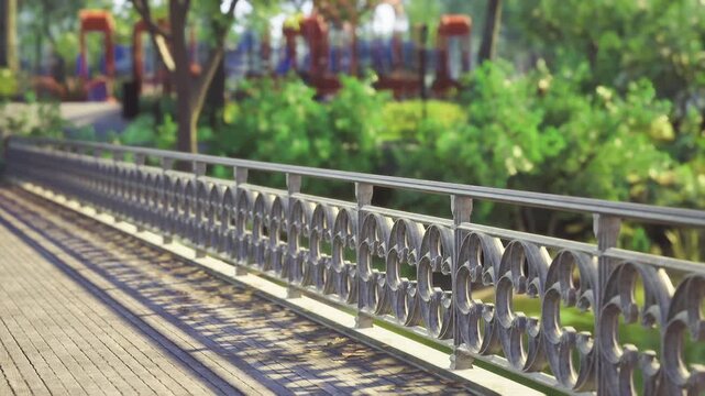 Decorative metal balustrade with blurred foliage, shallow depth, ornate curves catching sunlight, soft green bokeh background, elegant closeup for design
