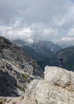 Hiker on a rock, Auronzo di Cadore, Belluno, Italy
