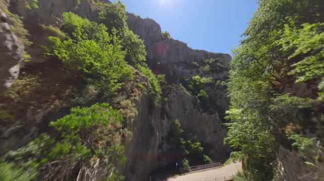 A fastpaced cinematic drone flight through a narrow rocky gorge in Asturias, Spain. Showcases authentic nature and ecofriendly travel destinations for wellness and adventure content.