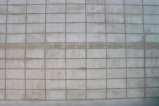 Gray concrete block wall texture background, modern industrial style exterior surface with clean geometric pattern for architectural design and copy space.