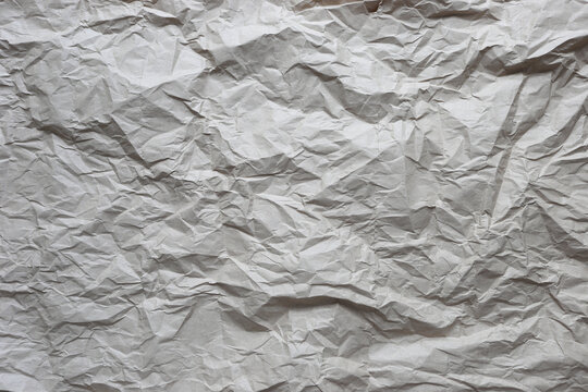 Wrinkled kraft paper texture background, brown recycled paper surface, rustic eco-friendly material for packaging design and creative copy space.
