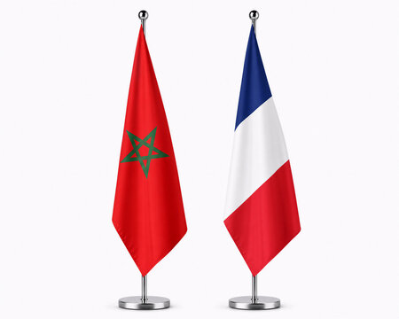 Two vertical flags, Moroccan with red background and green star, and French with blue, white, and red stripes, mounted on silver poles against a white background.