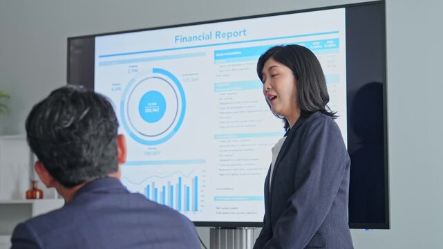  画面を見ながら会議するビジネスパーソンのグループ。プレゼン、セミナー、提案、講師、報告、発表、研修