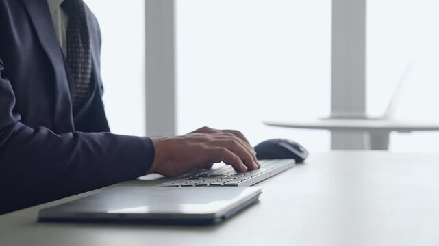A male business professional typing on a PC keyboard. Business, DX, IT, programmer, engineer, data entry.