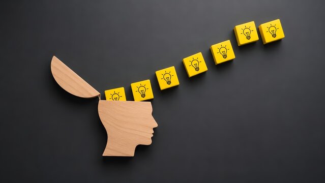 Creative brainstorming process concept featuring open wooden human head generating yellow blocks with glowing idea lightbulbs
