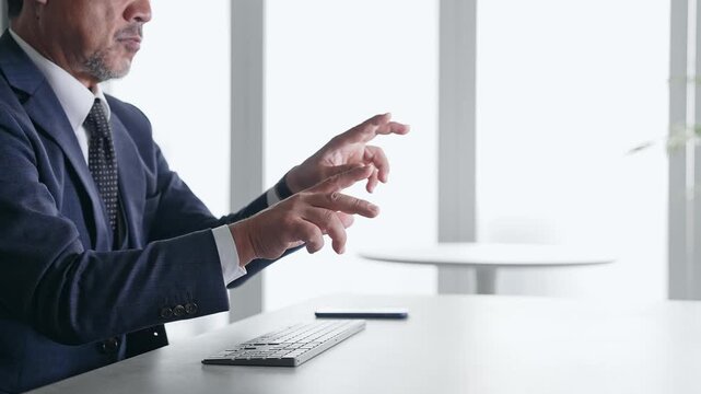 A male business professional interacting with a screen in mid-air. VR, virtual, hologram, operation, 3D image, office.
