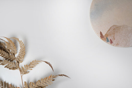 Minimal Flat Lay Background with Dried Fern and Ceramic Plate