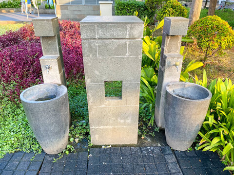 Outdoor stone hand washing stations and ablution sinks installed in a public garden park area
