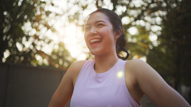 Asia young Gen Z people mindful happy woman open arm relax body deep stress relief outdoor nature green public park sun light self love anti aging life asian female mental health care modern medical.