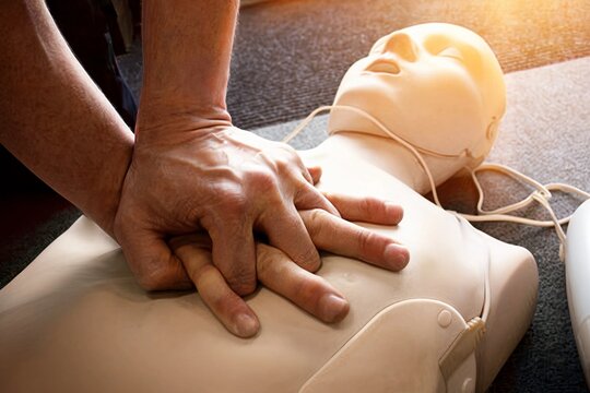 Performing CPR Chest Compressions on a Medical Training Manikin in a Classroom