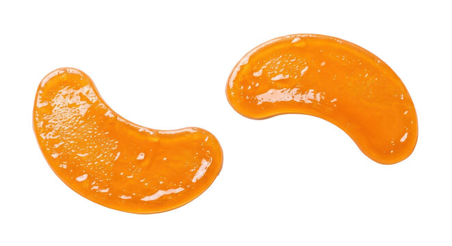 Close-up of two orange gel cosmetic samples on white background