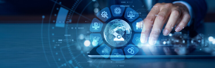 Fototapeta premium Smart manufacturing. Engineer working on tablet optimizing Industry 4.0 production lines in modern industrial world. Advanced automation, cyber-physical systems and connected factory data.