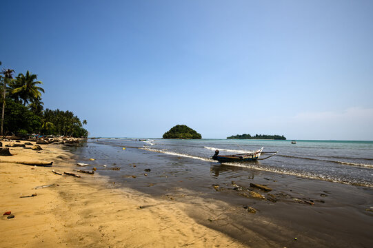 Tropical coastline with traditional fishing boat
