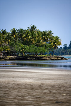 Wild Indonesian coastline facing verdant islets