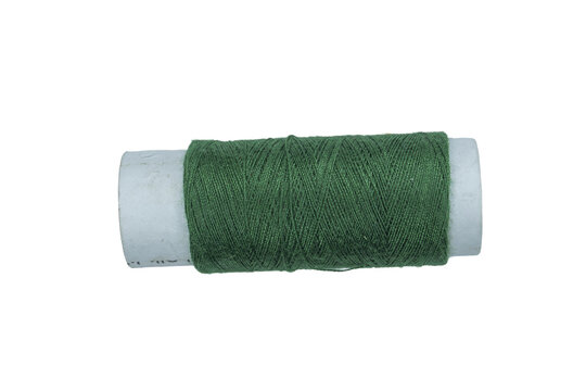 Green thread spool on transparent background close up isolated.