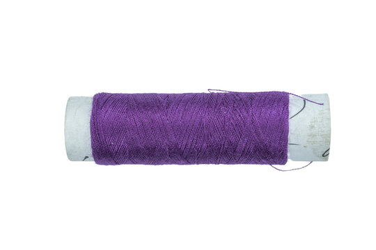 One purple cotton thread spool isolated on a transparent background for creation.