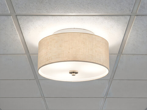 Modern beige fabric ceiling light fixture with white interior mounted on drop ceiling tiles