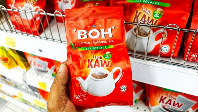Malaysia Kuala Terengganu 17 July 2026: Hand holding a product Tea Boh is a brand name of natural green tea display on the shelf in supermarket