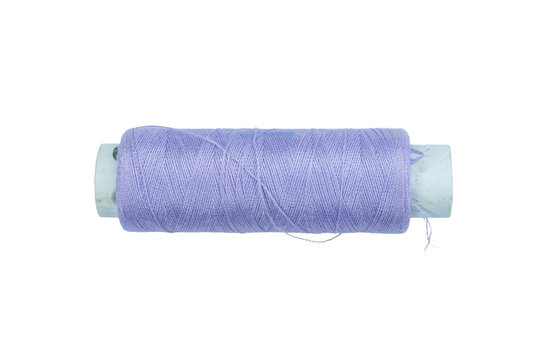 One spool of purple thread, partially unwound, for sewing and crafts on a transparent background.