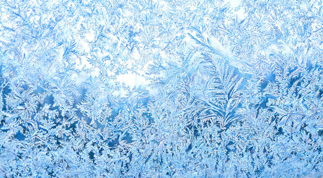 Frosted window glass with ice crystals texture background