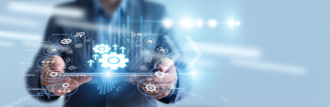 Robotics engineer hold tablet and monitors factory assembly lines powered by smart Automation, optimizing conveyor belt speeds and machine precision. Intelligent workflows boost production yield.