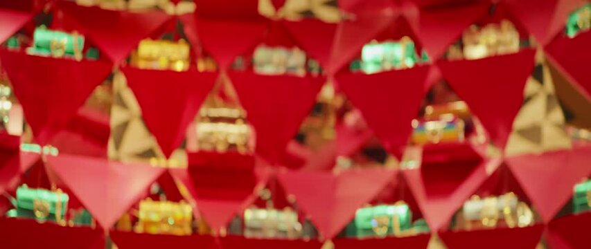 Blurred red display of luxury boutique with colorful accessories and lights background
