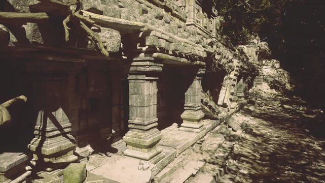 broad temple facade in bright daylight, detailed stone carving and monumental columns aligned along worn terrace, clear sky and crisp contrasts
