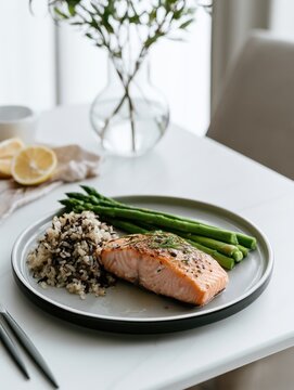 Salmon plate with asparagus and rice on white table