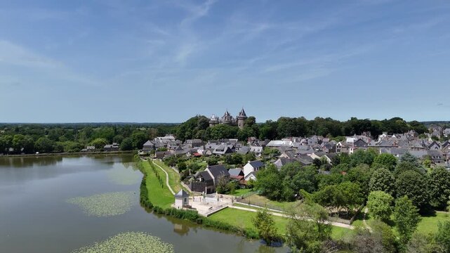 Low drone aerial view Comburgh town in Brittany France blue sky summer