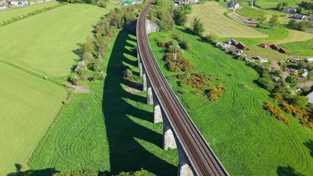 Aerial view of Craigmore Viaduct spanning green countryside near Bessbrook, farmland visible