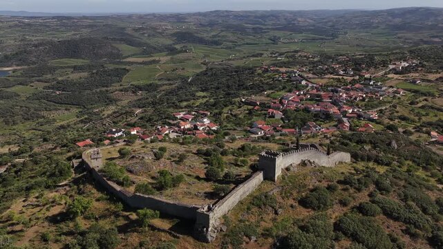 Stunning aerial footage of Numao Castle ruins with sweeping countryside vistas and a sunlit Portuguese village, captured in crisp, cinematic drone video.