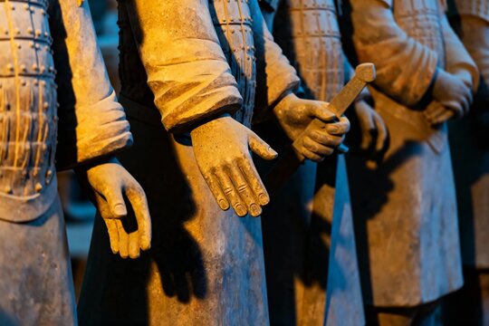 Close-up of terracotta warrior statues with detailed hands and armor