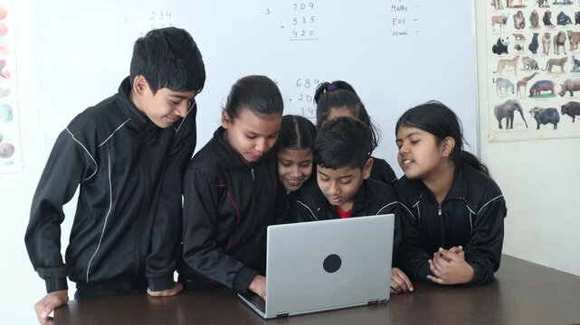 Group of indian students using laptop and learning AI together in a classroom, Technology and education in india.