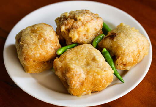 A plate of crispy stuffed tofu, also known as tahu kipas in Indonesia. A snack or appetizer consisting of deep-fried firm tofu pockets that are stuffed with various vegetables and shrimp.