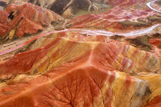 Aerial view of colorful layered rock formations in a desert landscape