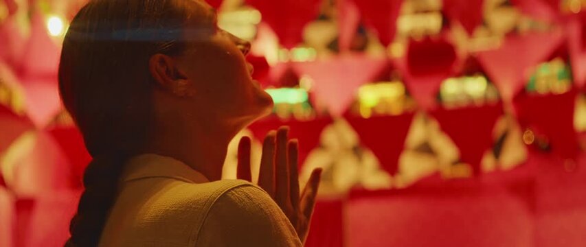 Happy woman admiring a shop window mesmerized by the luxury items inside