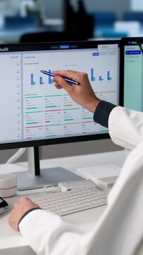 Medical Coder Carefully Reviews Patient Records Using Laptop