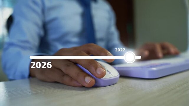 2026 to 2027 holographic progress bar on the virtual screen, Businessman using a computer mouse and keyboard with hologram 2026 to 2027 loading target arrow animation
