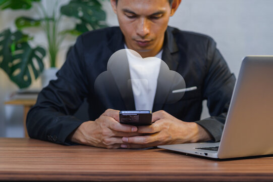 Businessman Using Smartphone with Cloud Computing Concept at Office Desk