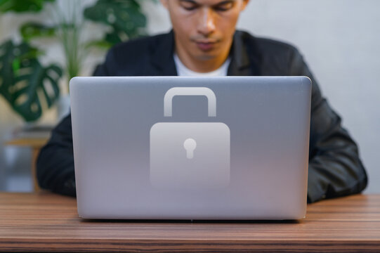 Businessman Working on Laptop with Security Lock Icon in Modern Office