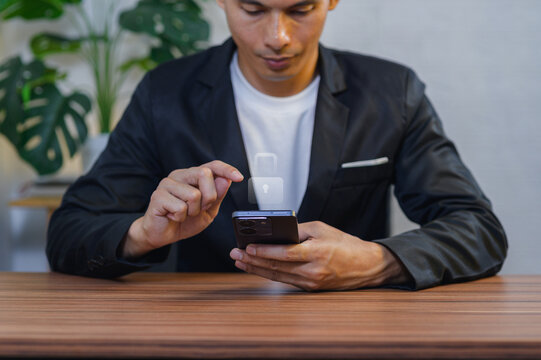 Businessman Using Smartphone for Contactless Payment at Desk