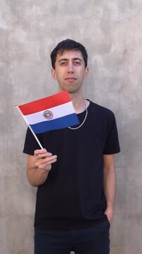 Man waving the Paraguayan flag in slow motion. Vertical shot.