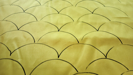 hand-drawn black scale-like pattern on bright yellow fabric. as wallpaper or graphic design © rio
