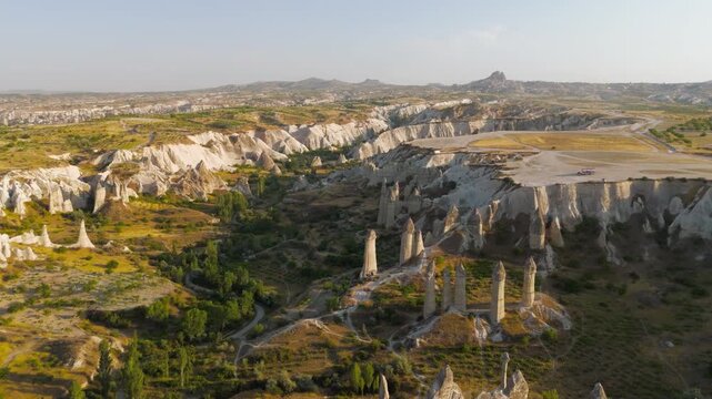 Goreme, Nevsehir, Turkey. Love Valley fairy chimneys, tall phallic tuff pillars with basalt caps, aerial panoramic view at golden hour over eroded Cappadocian landscape. Aerial View, MasterShots, Cir